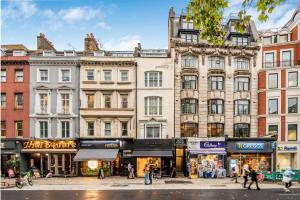 a group of buildings on a city street with people walking at Circlelet Luxury Private Suites in London