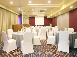 a conference room with white tables and white chairs at Marasa Sarovar Portico -Rajkot in Rajkot