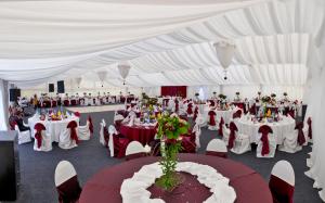 a large white tent with tables and chairs in it at Hotel ToacaBellevue in Gura Humorului