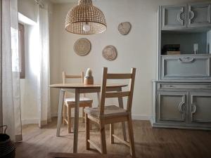 a dining room with a table and two chairs at La Casa del Chellero in Enguera