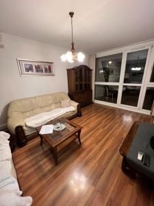a living room with a couch and a coffee table at Meszlényi Apartman II in Pécs +7 photos