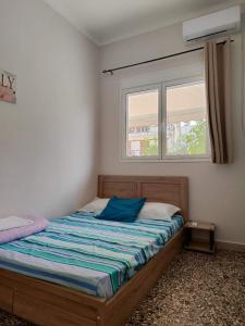 a small bedroom with a bed with a window at Family Inn in Athens