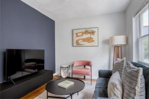 a living room with a couch and a tv at South Boston 2br w building wd nr seaport BOS-912 in Boston