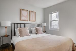 a white bedroom with a large white bed with pillows at South Boston 2br w building wd nr seaport BOS-912 in Boston