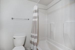 a white bathroom with a toilet and a shower at South Boston 2br w building wd nr seaport BOS-912 in Boston