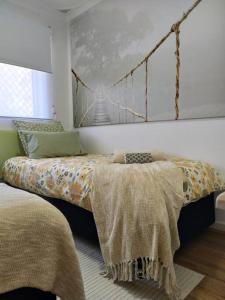 a bedroom with a bed with a bridge on the wall at Modern Unit Near CBD & Beach, Free Parking in Perth