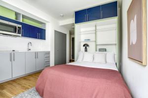 a bedroom with a large bed with blue cabinets at Ballard Studio w Rooftop BBQ nr dining SEA-175 in Seattle