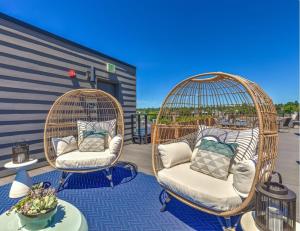two wicker chairs sitting on a patio with a table at Ballard Studio w Rooftop BBQ nr dining SEA-175 in Seattle