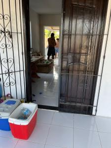 a person walking through a door into a room at Chalé meu príncipe in Marapanim