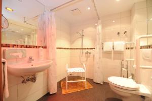 a bathroom with a sink and a toilet and a shower at Hotel Markkleeberger Hof in Markkleeberg +31 photos