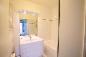 a white bathroom with a sink and a bath tub at Lovely appt between Paris&Disney in Noisy-le-Grand