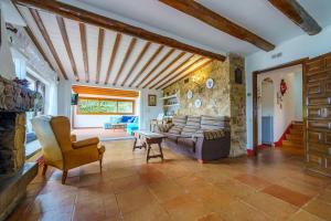 ein Wohnzimmer mit einer Couch und einer Steinwand in der Unterkunft Villa Mitjorn Cala Canyelles in Lloret de Mar