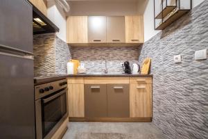 a kitchen with a sink and a stove at Katarina Premium Apartments in Pirot