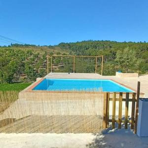 a swimming pool with a fence around it at Quinta das Reveladas in Marvão
