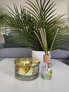 a vase sitting on a table with a plant in it at Agréable maison de ville avec jardin + garage. in Coulaines