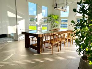 a dining room with a wooden table and chairs at An Blue House in Dazhou