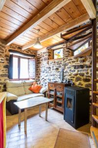 a living room with a couch and a stove at Casa de turismo rural Sardom2 in Bembibre