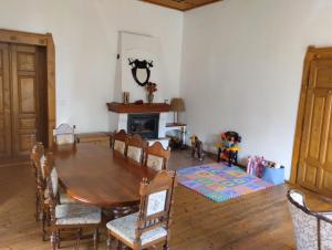 a dining room with a table and chairs and a fireplace at ŠulcBurg in Cetenov
