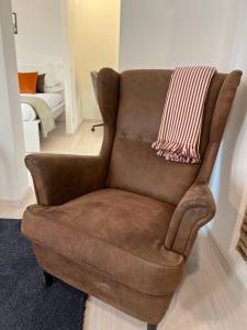 a brown chair with a blanket on top of it at Charming Navona in Rome