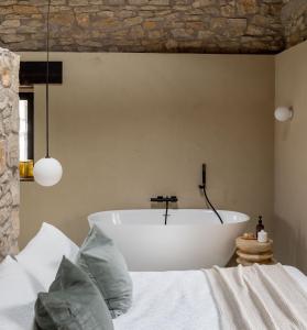 a bedroom with a bath tub and a bed at El Amparo de Narcisa 