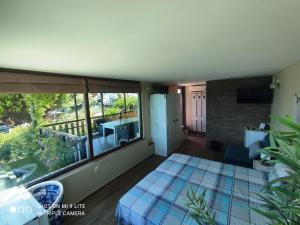 a bedroom with a bed and a balcony at Happy Beach Rooms in Varna City