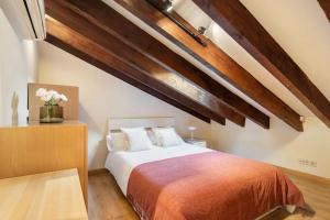 1 dormitorio con cama grande y techo de madera en Victor Apartments Plaza España, en Madrid