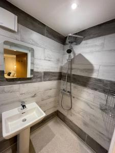 a bathroom with a sink and a mirror at HQ Pencadlys in Prestatyn