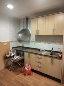 a kitchen with a sink and a stove at CASA ANTONIO in Murcia