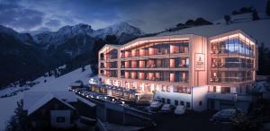 un gran edificio en medio de una montaña en Kronplatz-Resort Berghotel Zirm, en Valdaora