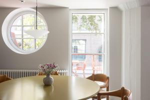 a dining room with a table and a window at Noli Katajanokka II in Helsinki