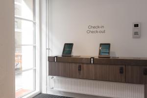 a check in counter with two computers on it at Noli Katajanokka II in Helsinki