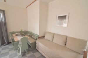 a living room with a couch and a table at Cottage on Diamond Street in Swakopmund