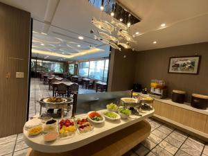 a buffet in a restaurant with many bowls of food at Etung Hotel in Taichung