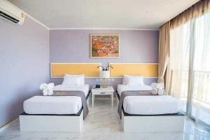 Ένα ή περισσότερα κρεβάτια σε δωμάτιο στο Mekong Heritage Hotel