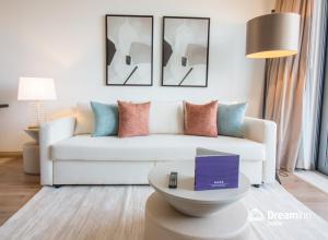 a living room with a white couch and a table at Dream Inn Dubai Apartments- Premium 1BR Connected to Dubai Marina Mall in Dubai