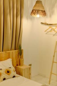 a bedroom with a bed with a curtain and a lamp at Pallet Homes - Landheights Tropics in Iloilo City