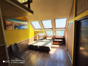 a bedroom with a bed in a room with windows at Hemingway rooms in Happy Beach in Varna City