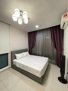 1 dormitorio con 1 cama grande y cortinas moradas en H2O Residences Ara Damansara PJ, en Petaling Jaya
