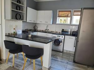 a kitchen with a counter and a sink and a dishwasher at Lovely apartment Back-up power in Sandton