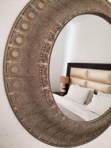 a mirror on a wall with a bed in a room at Lovely apartment Back-up power in Sandton