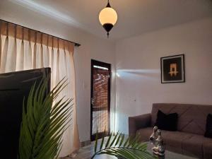 a living room with a couch and a window at Lovely apartment Back-up power in Sandton