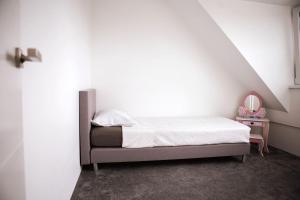 a bedroom with a bed and a small table with a mirror at Luxurious House in Kerkrade Center in Kerkrade