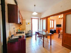 a kitchen with a table and a dining room at La Casa in Piazza in Toffia