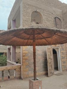 a large umbrella in front of a building at Pyramids view in Giza