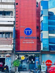 a red building with a tti sign on it at TT Hostel in Vientiane