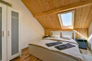 a bedroom with a large bed with a wooden ceiling at Fekete Rigó Vendégház in Egerszalók