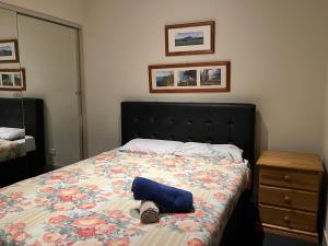 a bedroom with a bed with a blue pillow on it at Spacious, Central 2 QB Melbourne CBD Apt near Flinders Stn, Town Hall in Melbourne