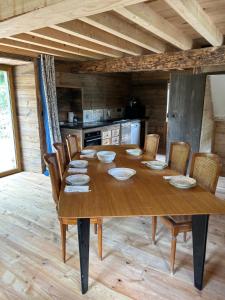 a large wooden table in a kitchen with chairs at chalet en montagne in Lées-Athas