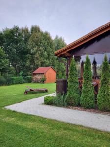 a garden with a pavilion and a house with trees at Domek całoroczny na Kaszubach / koło Chmielna in Przewóz