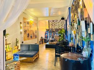 a lobby with a couch and a table in a room at TT Hostel in Vientiane